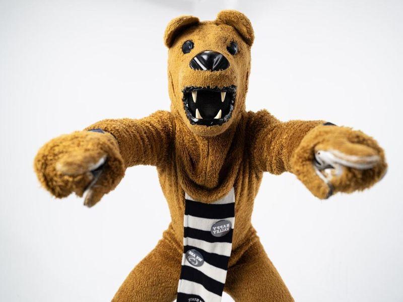 The Nittany Lion points to the camera with both hands