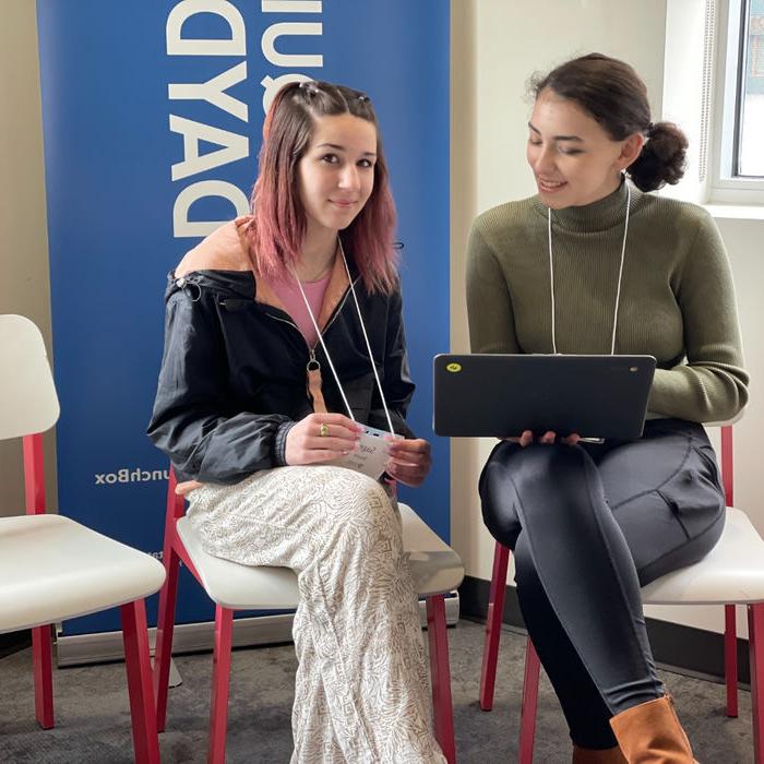 Two students looking at a computer.