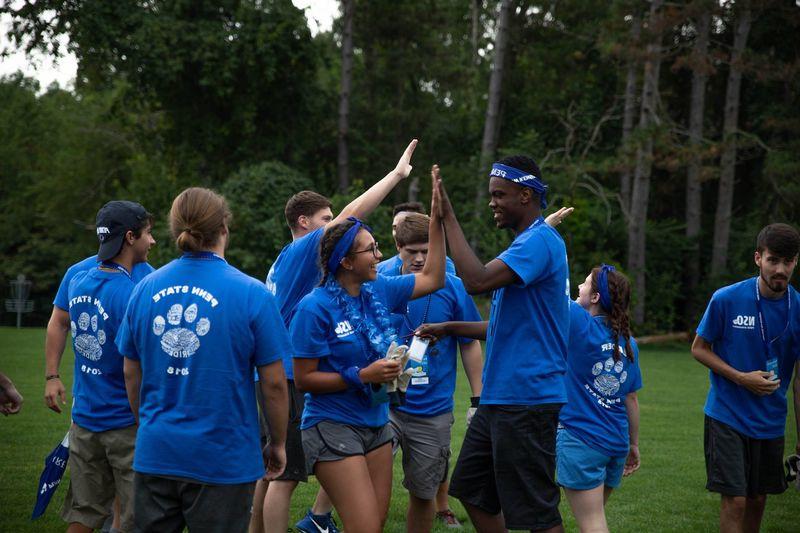 Two students high-five during games