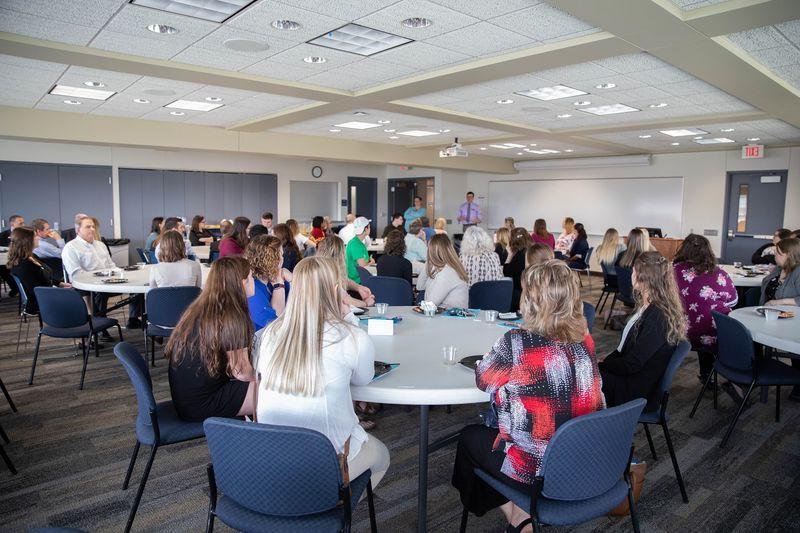 People sitting at tables in large conference center