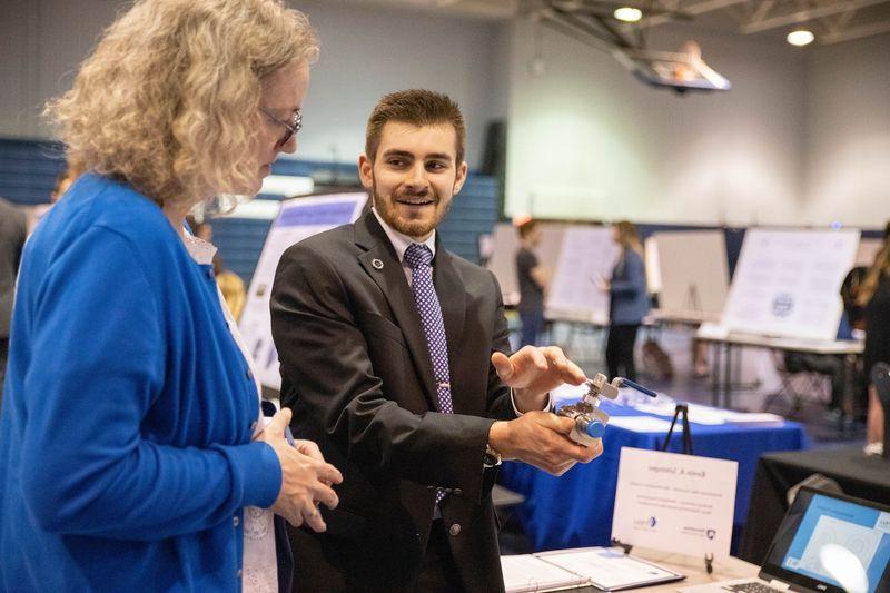 Student talks to woman about research