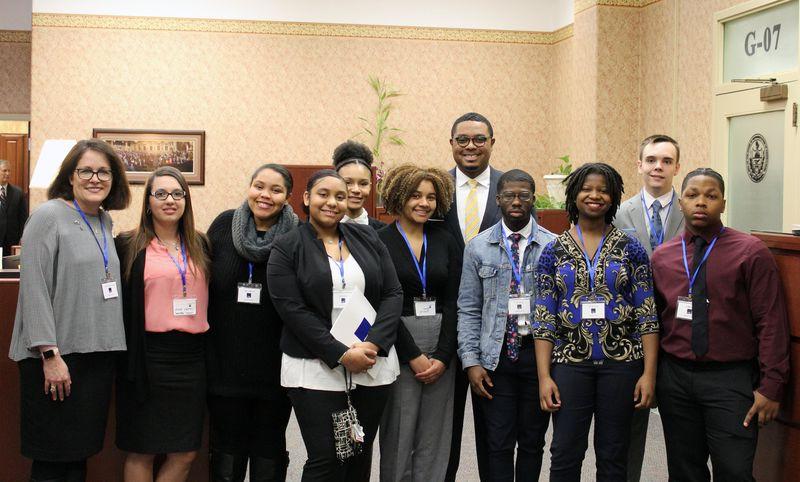 Students, staff, and representatives smiling