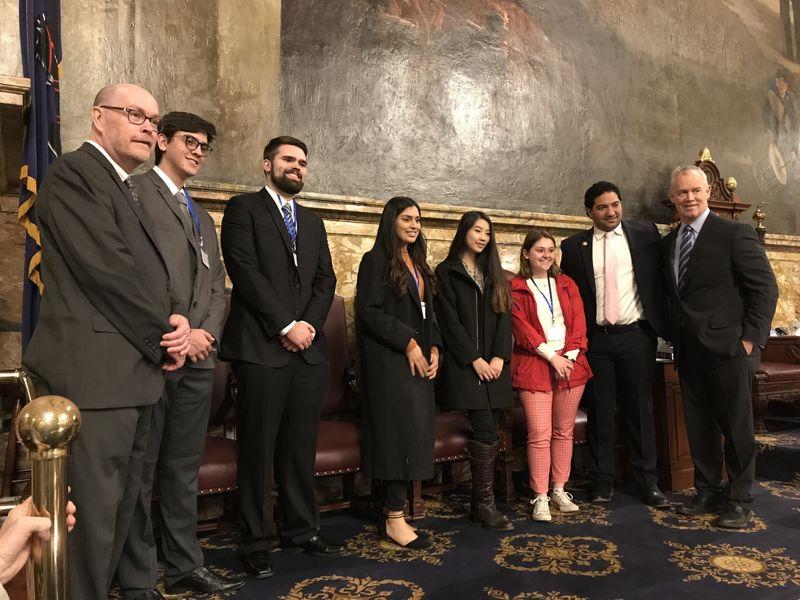 Students and representatives standing together smiling for a picture. 