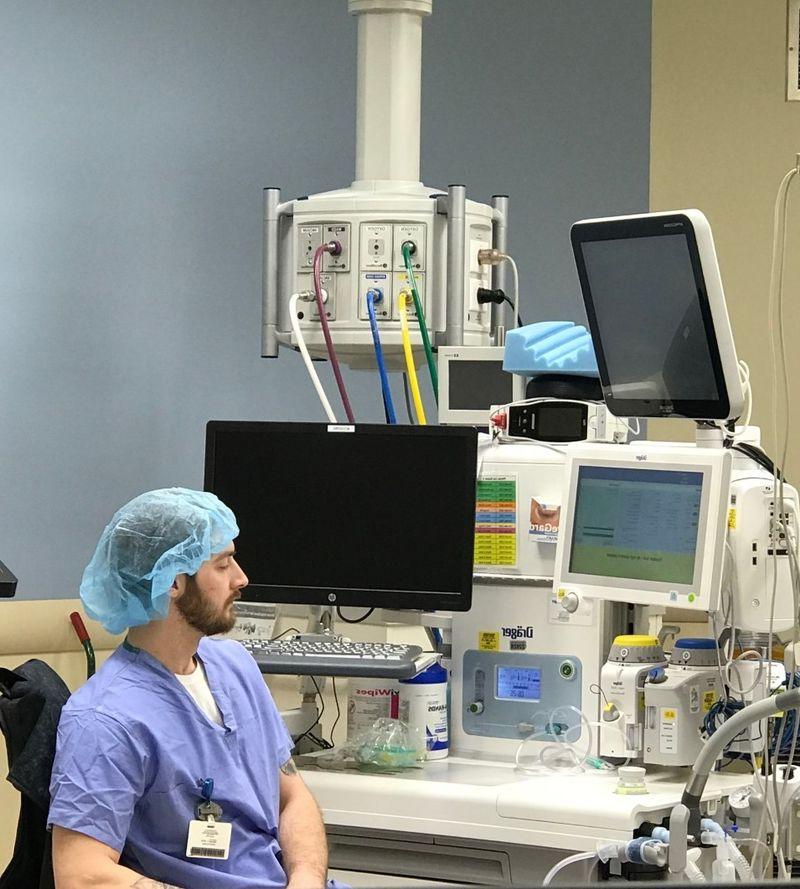 Man sits near hospital equipment