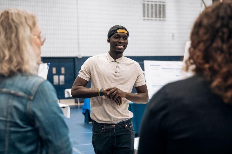 Student smiles at research fair