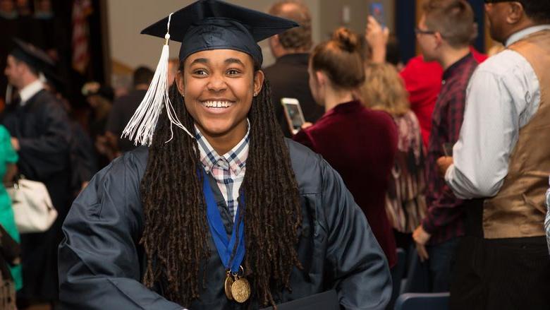 Beaver student Khalia Adams smiles as she walks up the aisle after the commencement ceremony.