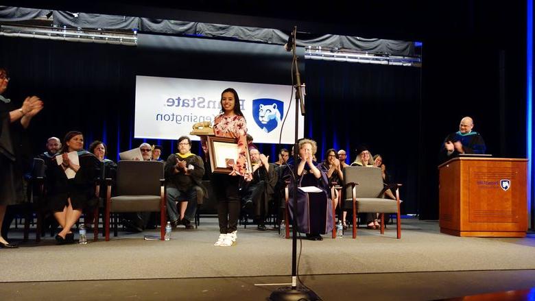 Paulina Iniguez stands on stage after receiving the 2018 Walker Award