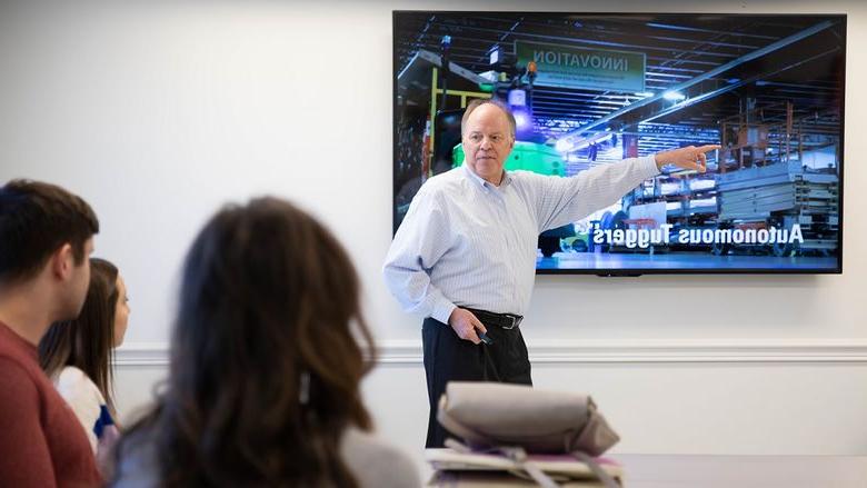 Man points to presentation