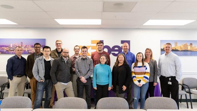 Group of men and women gather for group photo