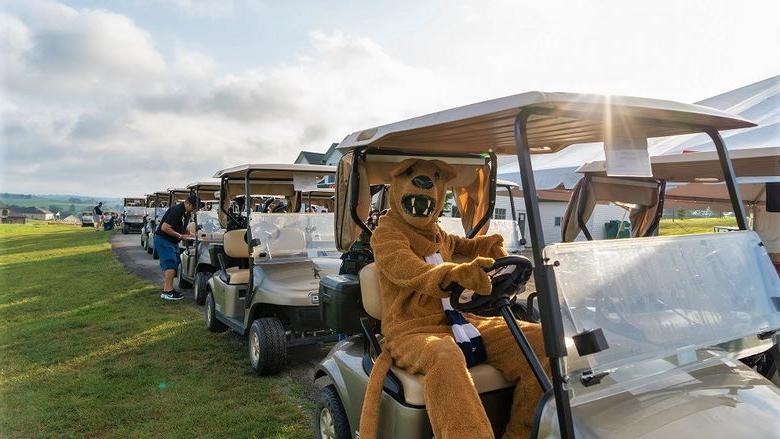 Nittany Lion mascot sits in golf cart