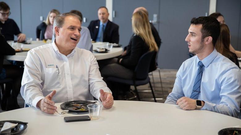 Two males talking during lunch