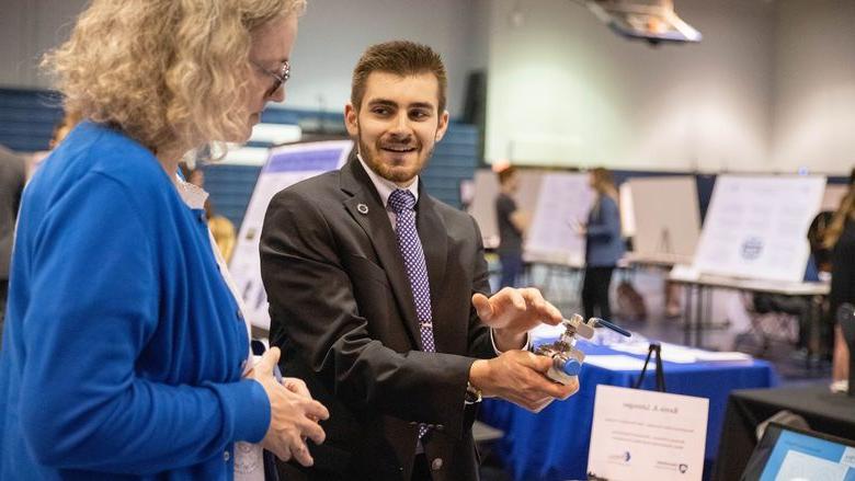 Student talks to woman about research