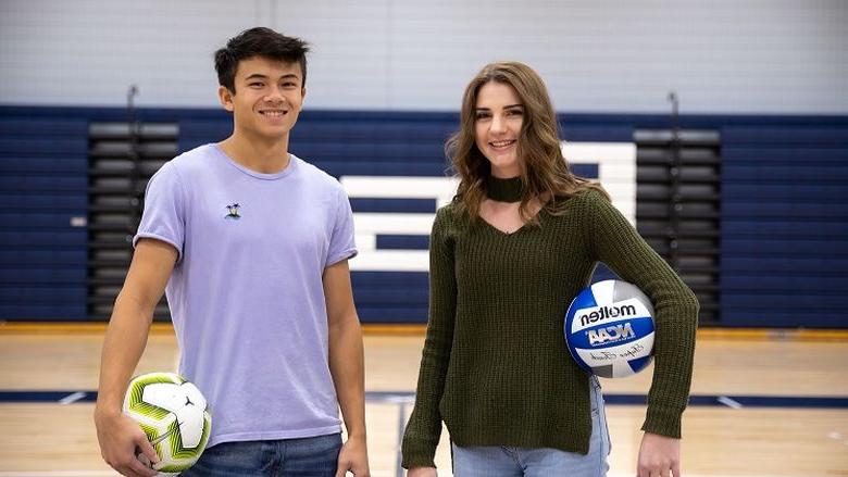 Woman and man stand in gymnasium