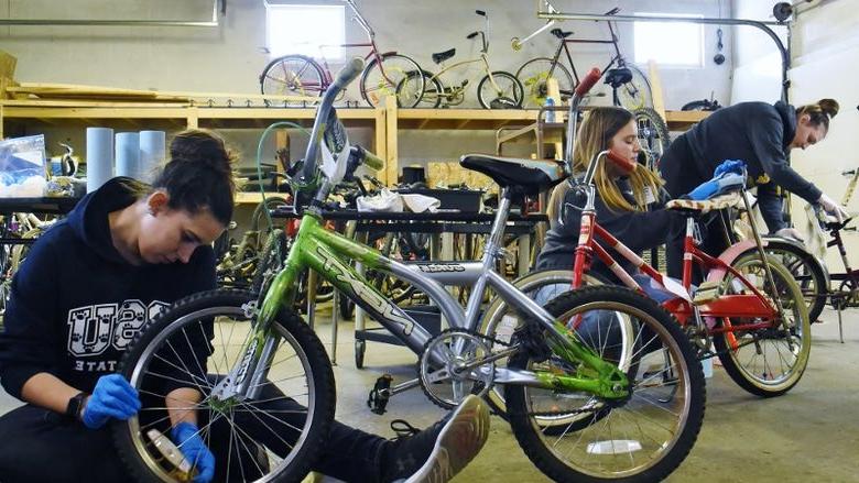 Penn State students repair bicycles during a Martin Luther King Jr. Day service project.