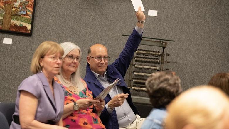 Man holds up number during art auction