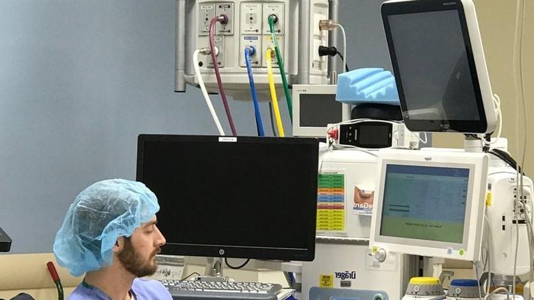 Man sits near hospital equipment