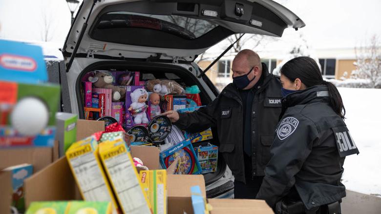 警察 officers load cruiser with donated items