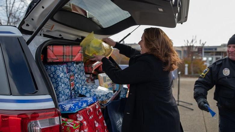 Woman places gifts in car