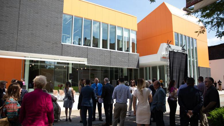 People stand outside building before event