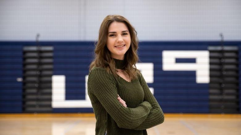 Kaylea Flick stands in gymnasium