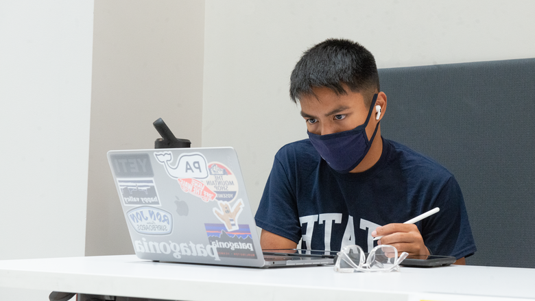 Student looking at a laptop computer