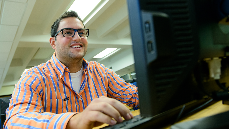 Student sitting in front of desktop computer screen