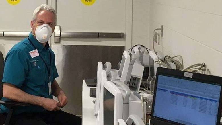 Man sitting next to medical equipment