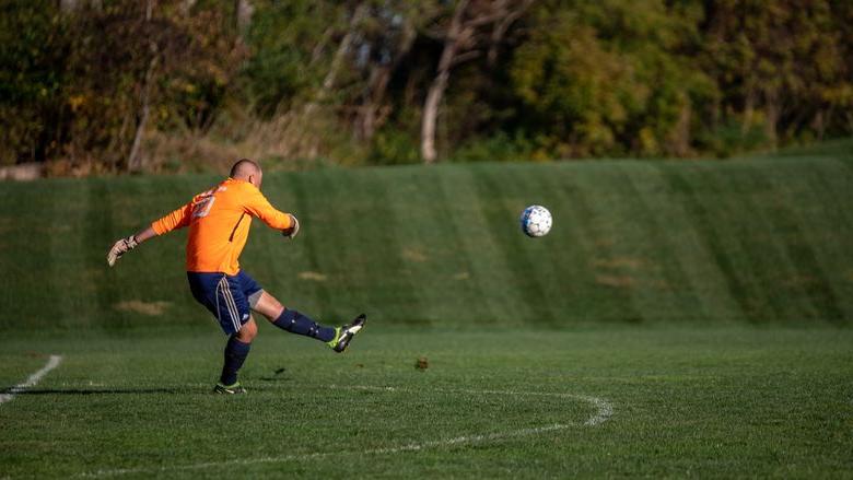 Man kicks soccer ball