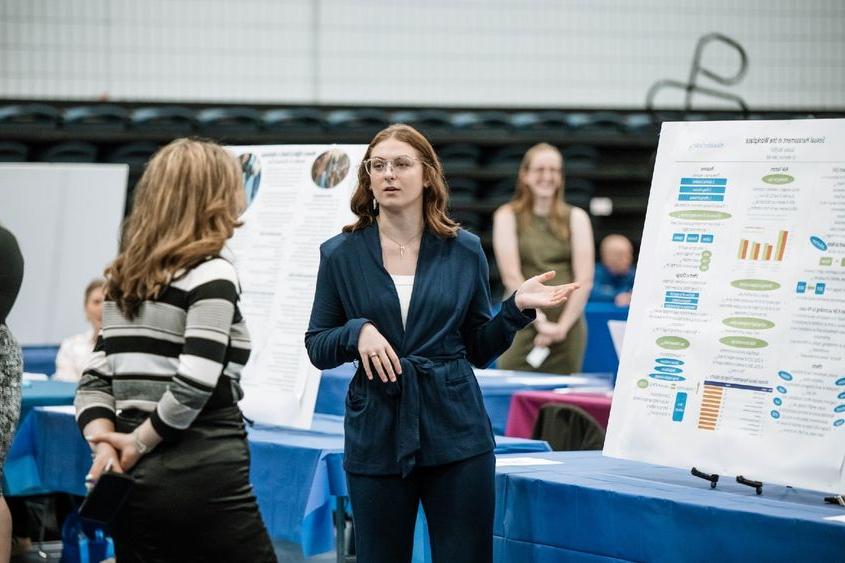 Student presents her research project at annual exposition