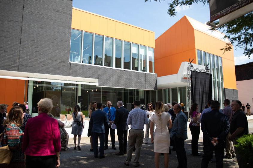 People stand outside building before event